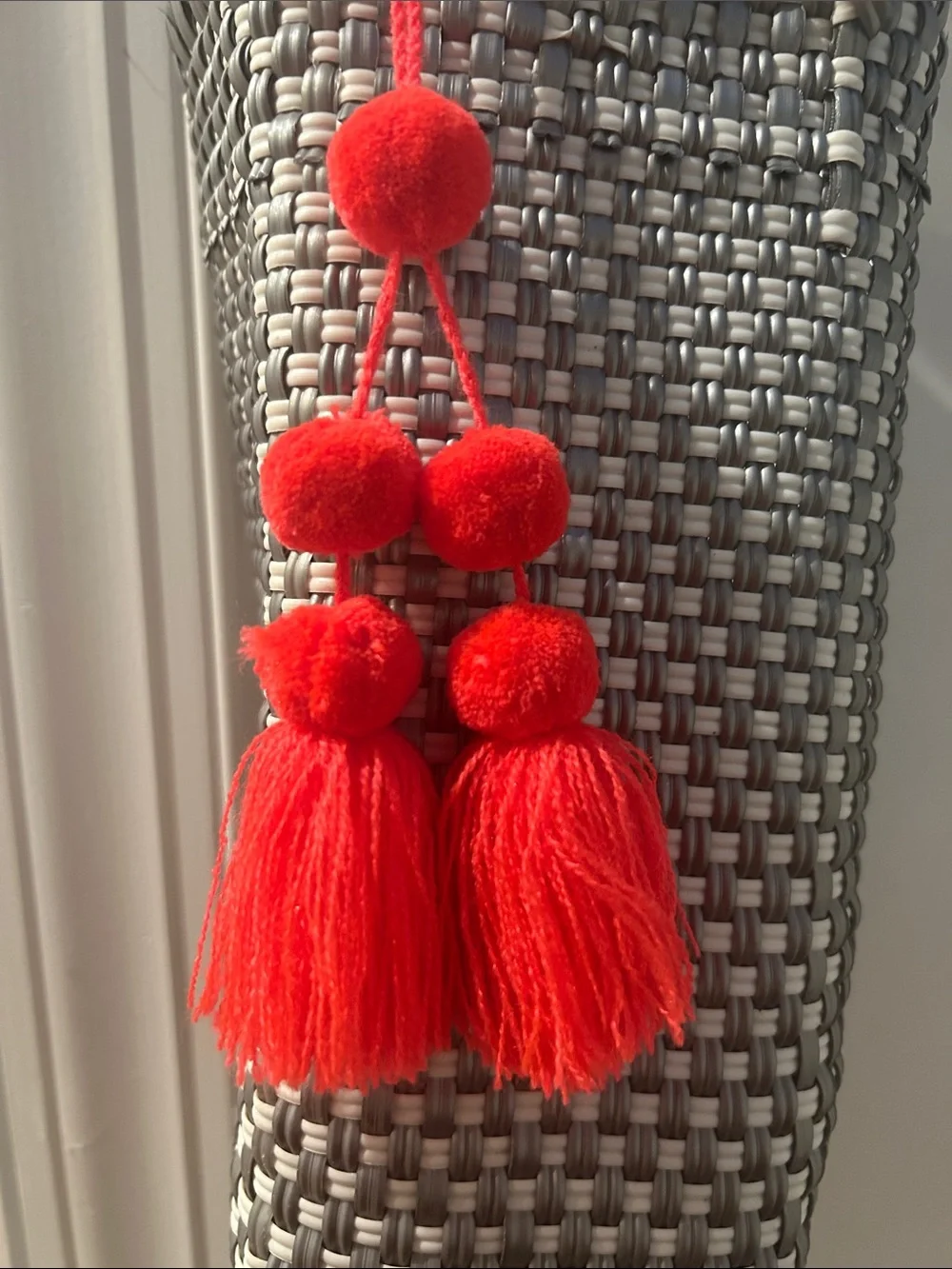 Woven Gray Tote Bag with Red Tassel Accent